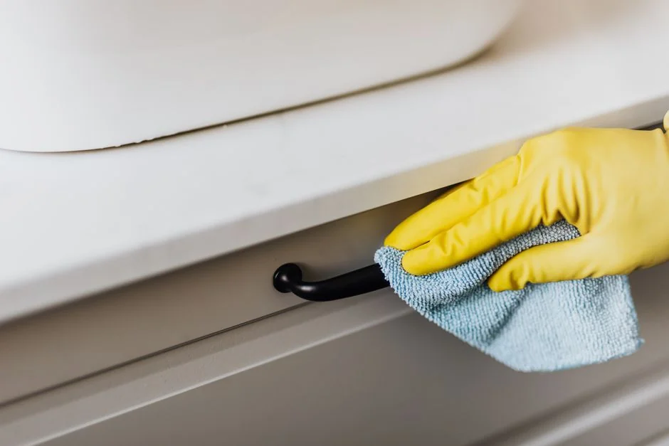 a-yellow-wall-with-a-blue-and-white-towel-from-it-bvrjbcmn0eu